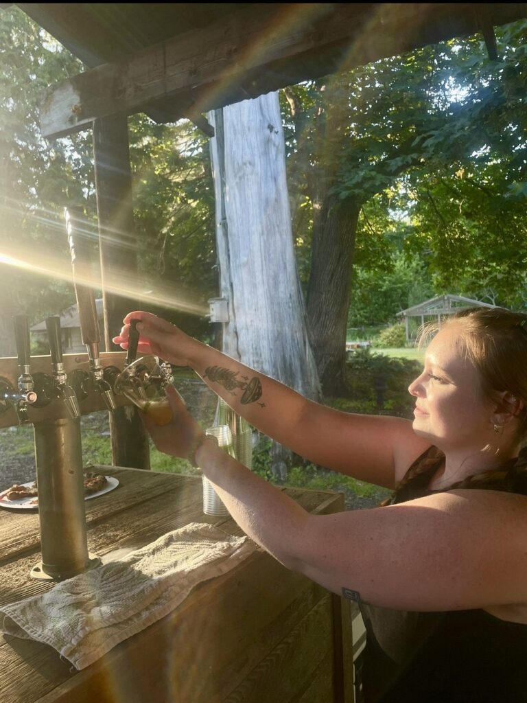 Chloe managing beer taps at a private party