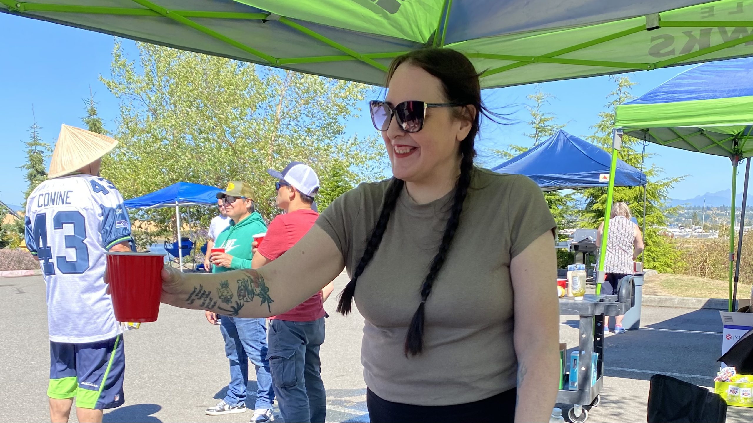 Woman pouring beer at an outdoor corporate BBQ event in Everett, Washington.