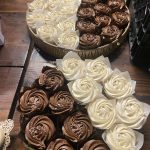 Close-up of cupcakes on rustic wood dessert table at Washington mountain wedding