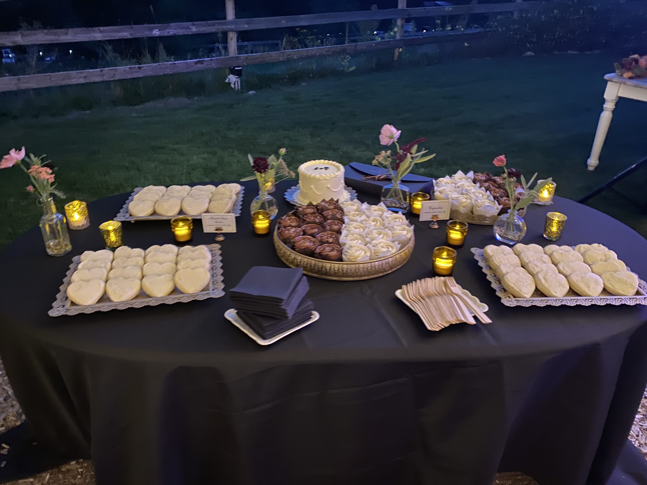Rustic dessert table with cupcakes and cookies at Brown Family Homestead wedding